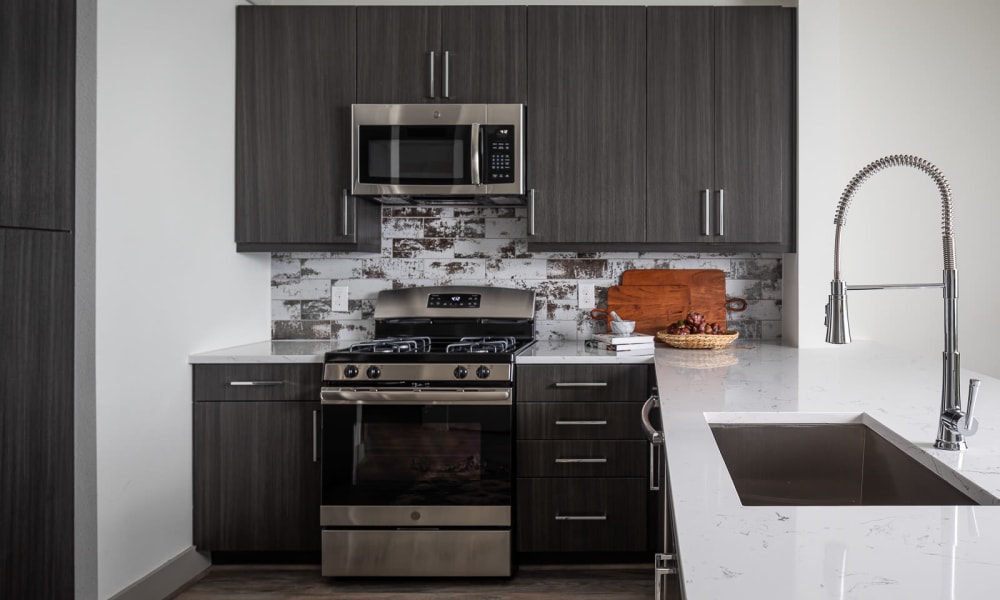 Model kitchen with stainless-steel appliances at Bellrock Summer Street in Houston, Texas