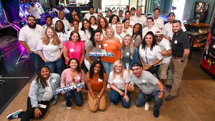 Employers of an organization posing with happiness together