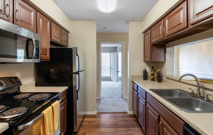 Kitchen with plenty of storage space at The Logan in Bedford, Texas