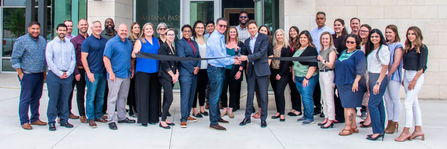 Team members at a ribbon cutting ceremony for Campus Life & Style in Austin, Texas