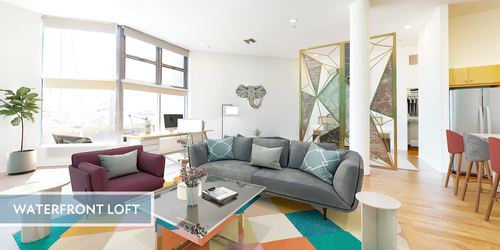 Spacious loft apartment's living room with waterfront views and hardwood floor at Esprit Marina del Rey in Marina del Rey, California