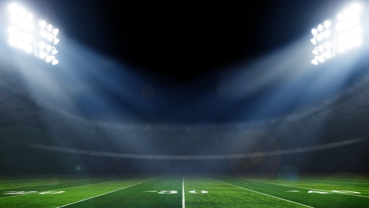 Empty Utah football stadium at night near Olympus at the District
