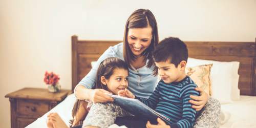 A mother reading stories for her children at Jefferson Cunningham Apartments in Los Angeles, California