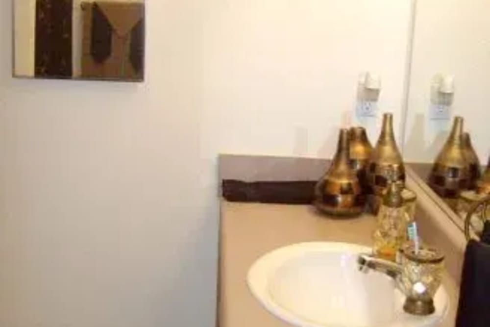 Bathroom with a mirror and a sink at Ochlockonee Pointe Apartments in Midway, Florida