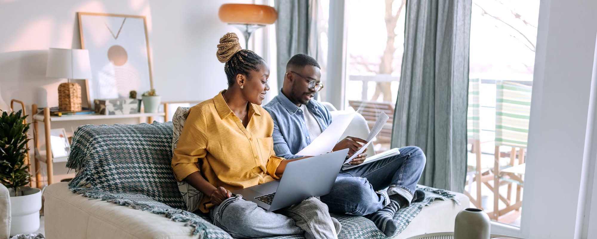 Accessibility Statement | A couple sitting cozily at their apartment at Tides at Desert Pointe in Las Vegas, Nevada