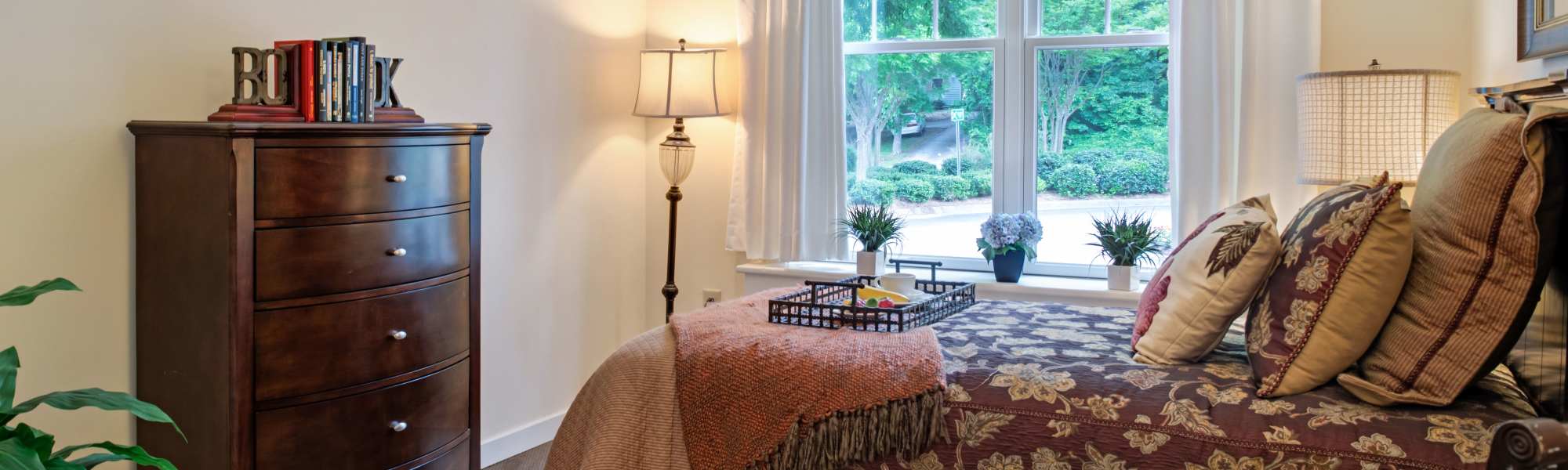 Spacious bedroom with large window and storage unit at Glenncrest at Buckhead in Atlanta, Georgia