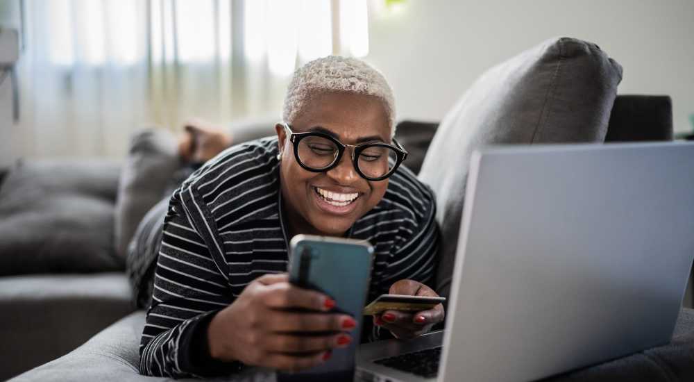 Resident using laptop for online payment at Mount Hope Lofts in Rochester, New York