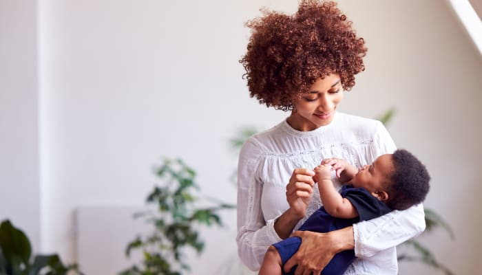 Resident holding her baby at The Lyndon in Irving, Texas