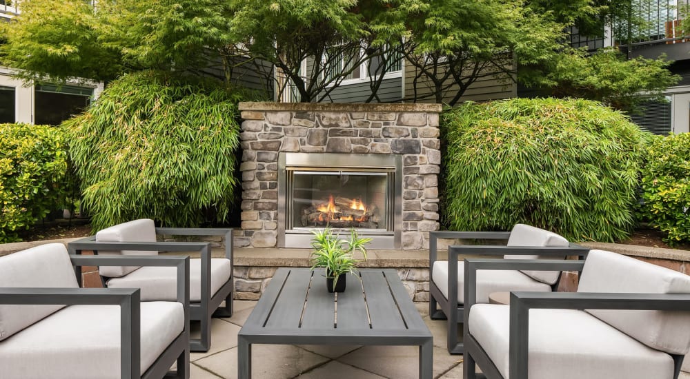 Outdoor umbrella seating with fireplace at Chateau Woods in Woodinville, Washington