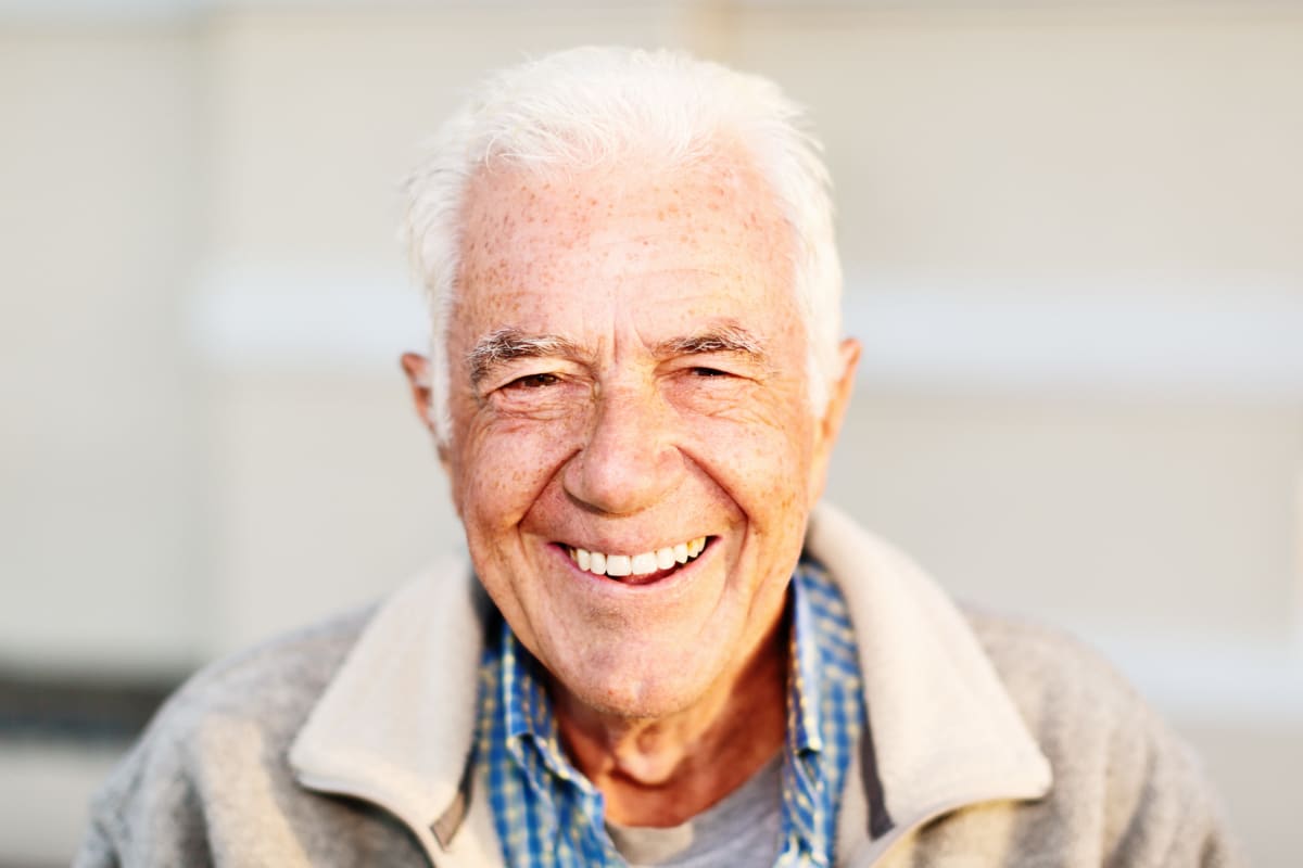 Resident smiling into the camera at Crescent Senior Living in Sandy, Utah
