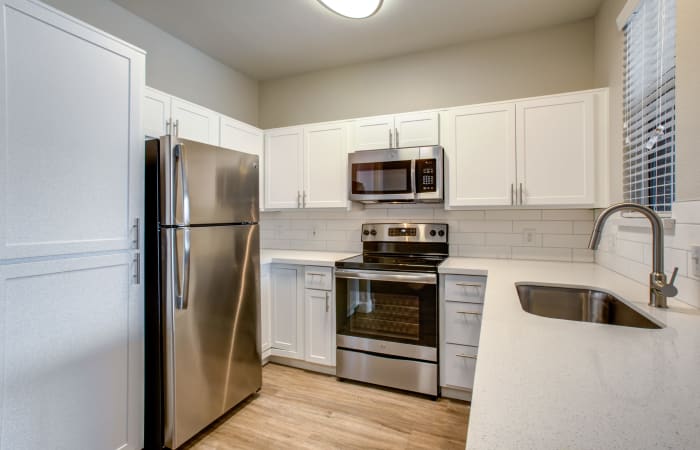 Recently renovated kitchen with stainless-steel appliances in an apartment home at Sierra Canyon in Glendale, Arizona