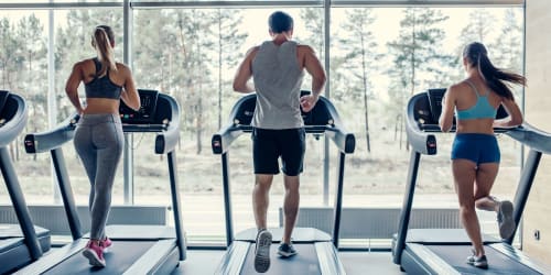 Residents running on treadmills in the fitness center t Affordable Apartments at Vasco Station in Livermore, California