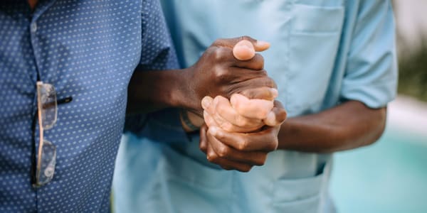 Resident  holding hands with caregiver at Transitions At Home - Central in Stevens Point, Wisconsin