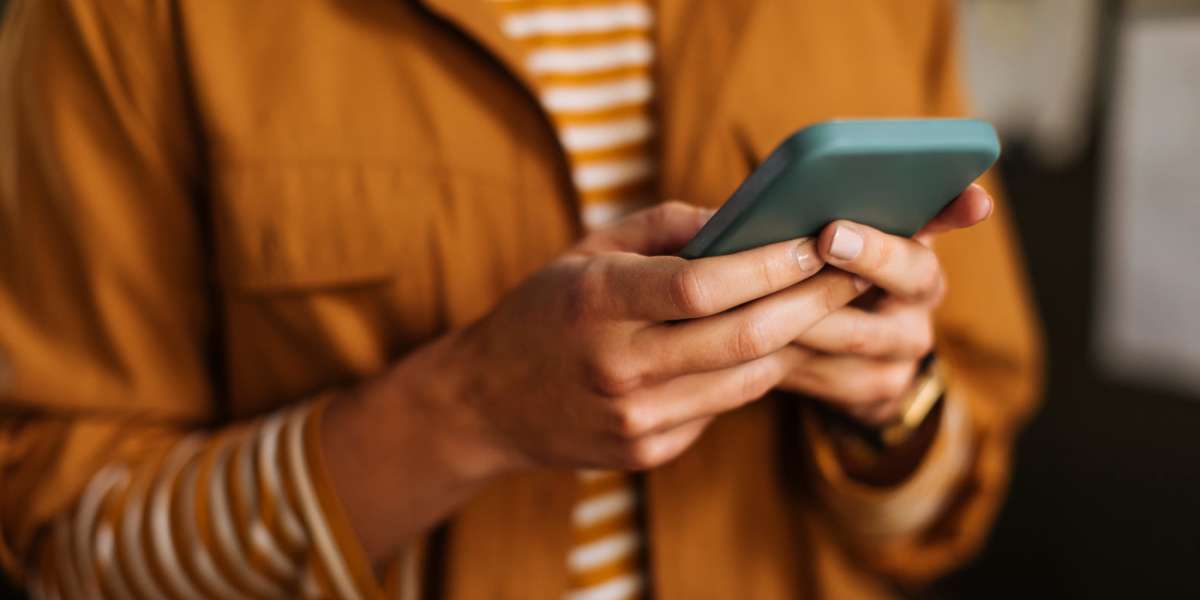 Resident looking at their phone at Wilhoit Properties, Inc. in Springfield, Missouri