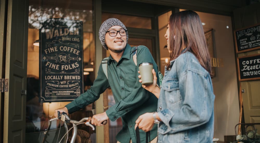 Residents chatting outside a coffee shop near Riverstone Apartments in Sacramento, California