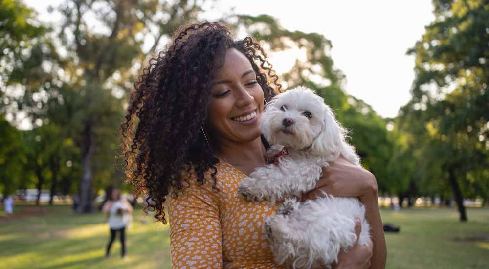 Resident cuddling her pet at Bella Vista Apartments in Santa Clara, California