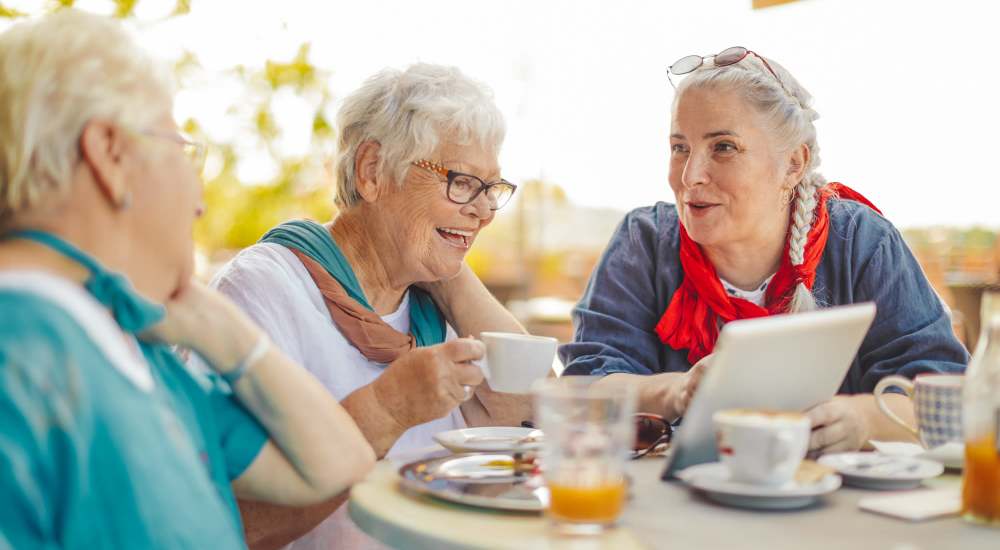 Senior residents enjoying food at a restaurant near Columbia Tower in San Diego, California