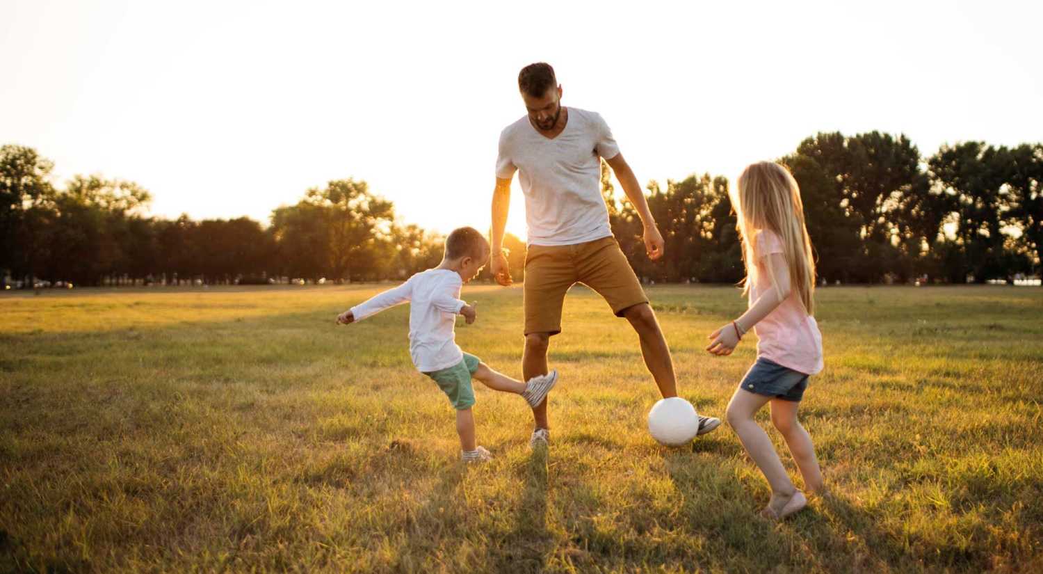 Resident playing with hi kids in a park near Dawcrest Apartments in Olympia, Washington