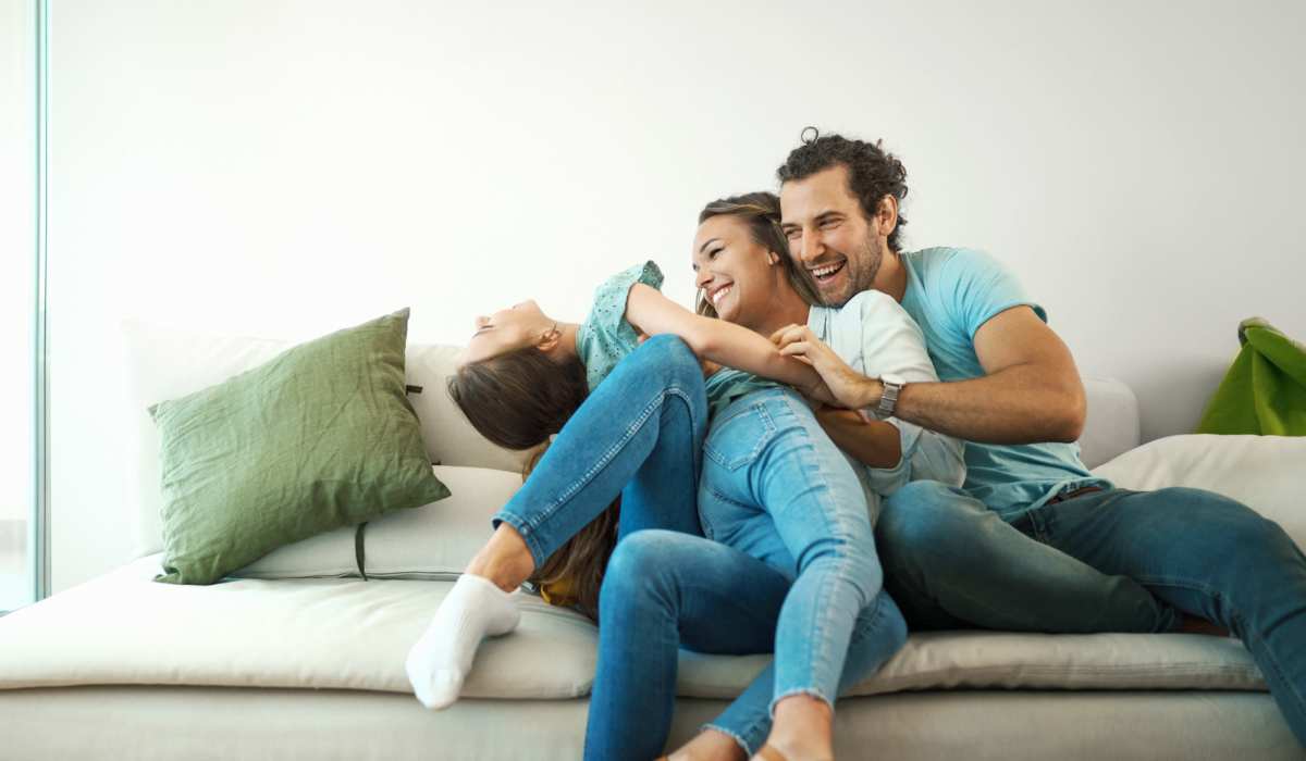 Happy family in their living room at Walnut Apartments in Philadelphia, Pennsylvania