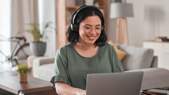 person smiling and working in their apartment