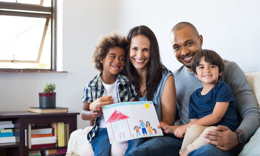 Happy family posing for a picture, in the living room at The Meadows in Sparks, Nevada
