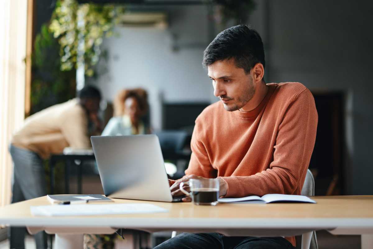 Resident working on his laptop at Dunes Apartments in Seminole, Texas