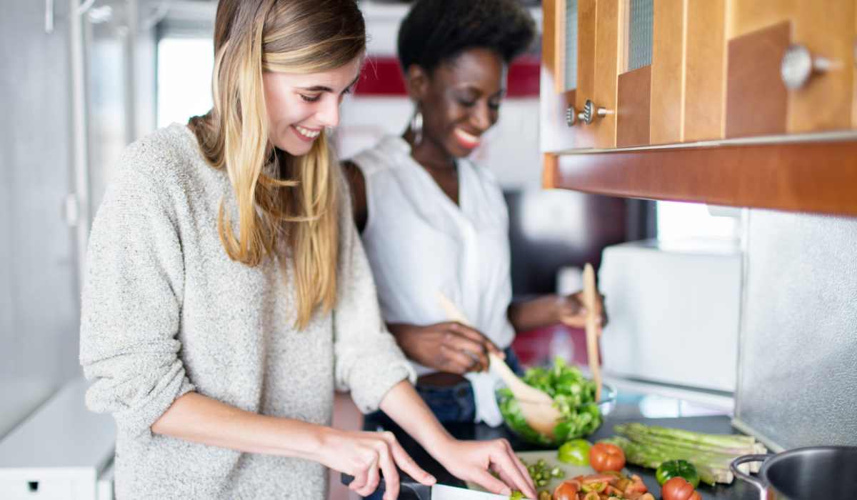 Resident couple preparing a meal together in their home at Sphere Apartments in Richmond, Virginia