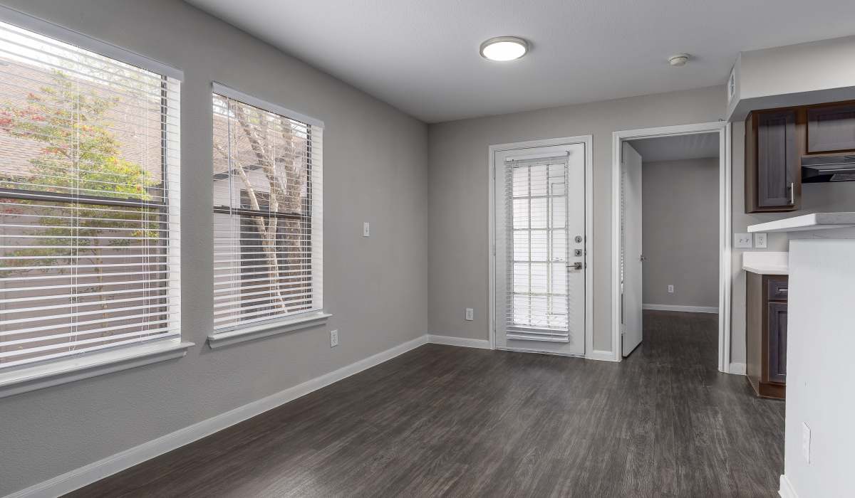 Living area with large windows and patio access at Oaks of Kingwood Apartments in Kingwood, Texas