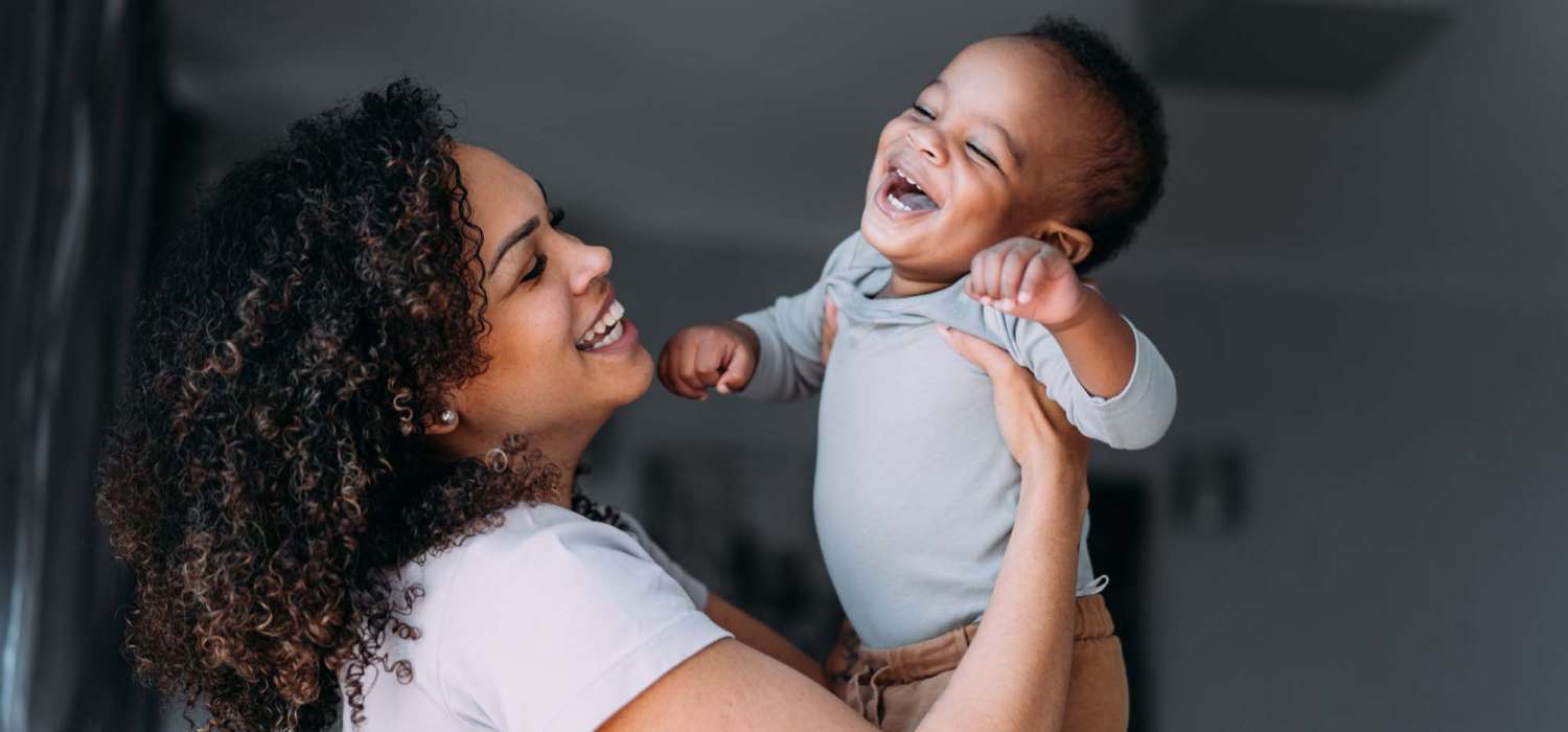 Resident playing with her kid at Village Apartments in Bellaire, Michigan