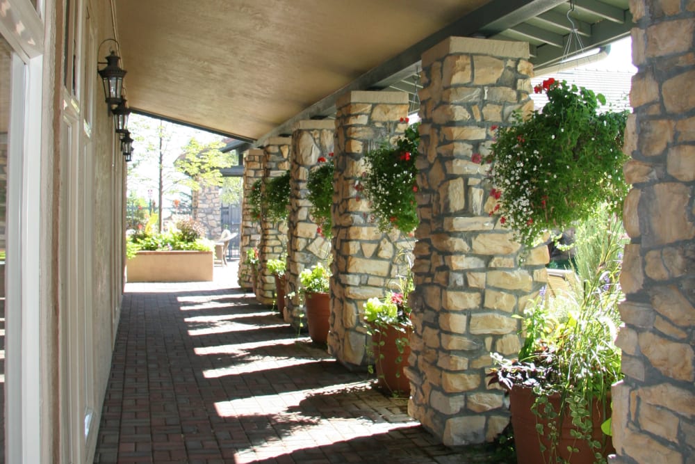 Veranda with hanging baskets outside the clubhouse at Montrachet Apartment Homes in Lakewood, Colorado