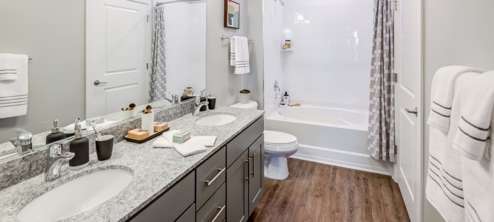 Spacious bathroom with large mirror and ample counter space at Flats At 540 in Apex, North Carolina