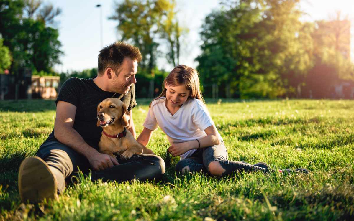 Resident family relaxing at a local park with their pet dog near Kirman Garden in Reno, Nevada