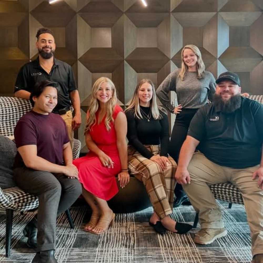 Smiling employees at Drucker + Falk in Newport News, Virginia