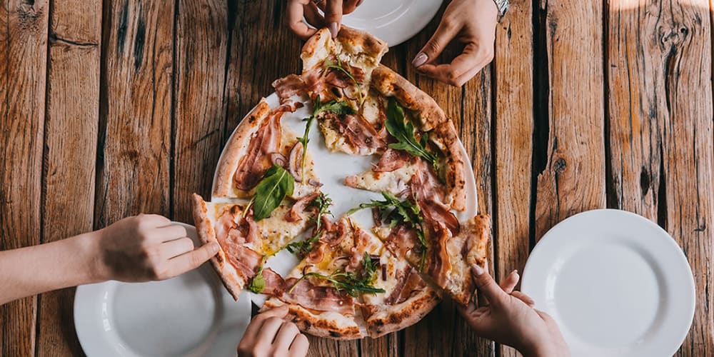 Residents grabbing slices of pizza near Bon Aire Apartments in Castro Valley, California