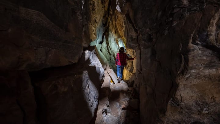 Woman exploring amazing cave