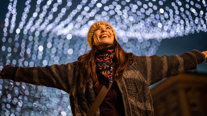 Young smiling woman spinning with outstretched arms