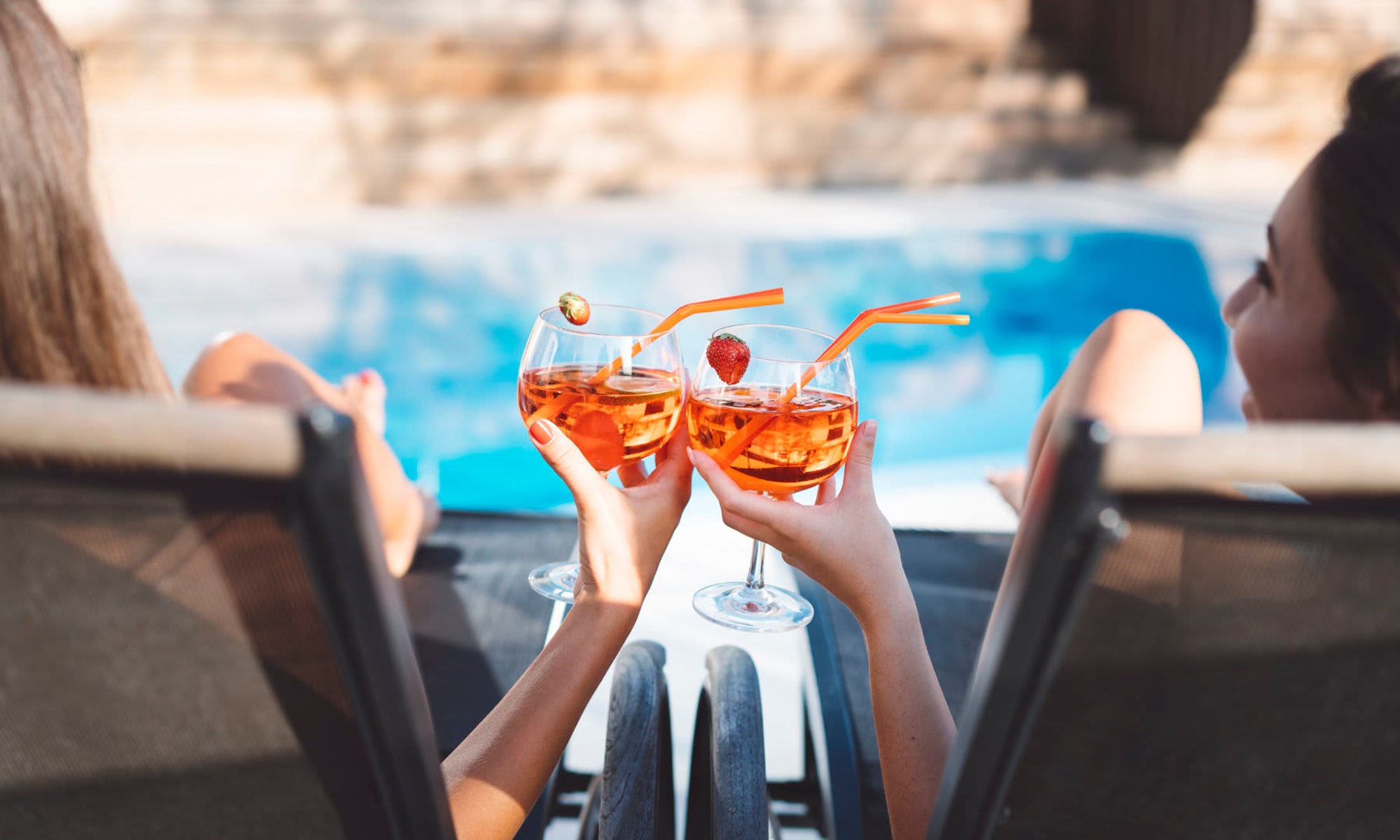Residents have a poolside cocktail at Quintana at Cooley Station in Gilbert, Arizona
