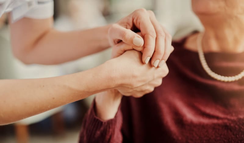 Family members holding hands at Hayden Grove Senior Living in Bloomington, Minnesota