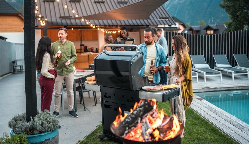 Friends hanging out around a backyard grill and firepit at Golden Villas in San Diego, California