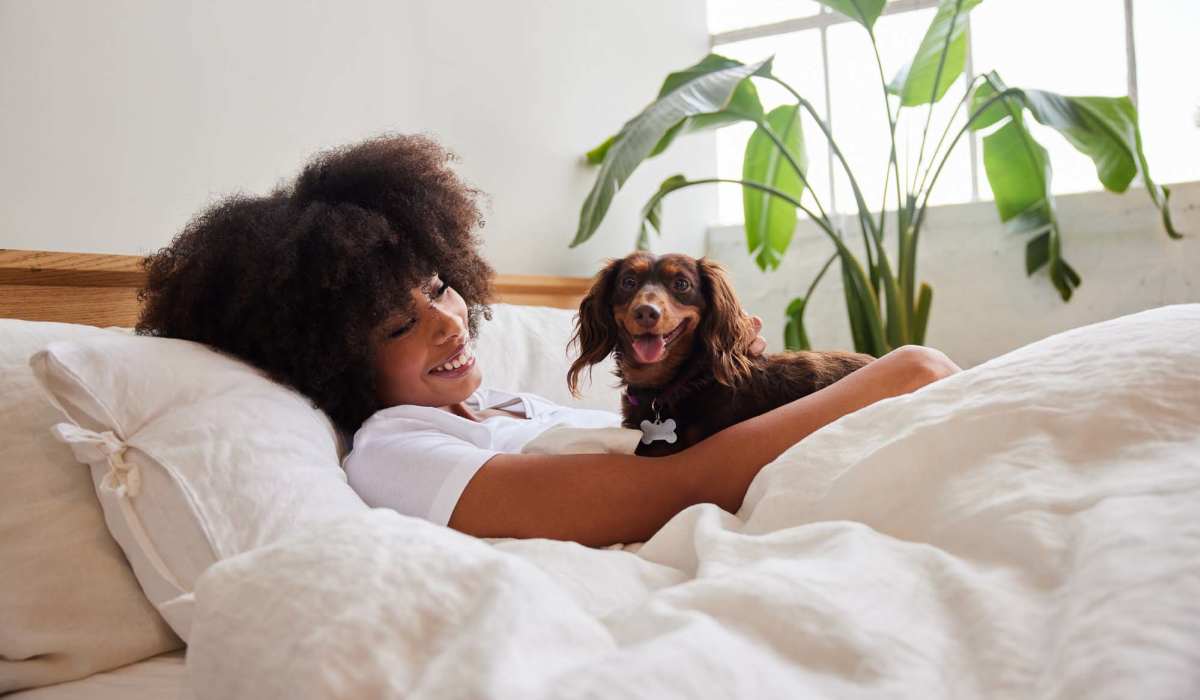 Resident palying with her dog at Alston Arms Apartments in North Charleston, South Carolina