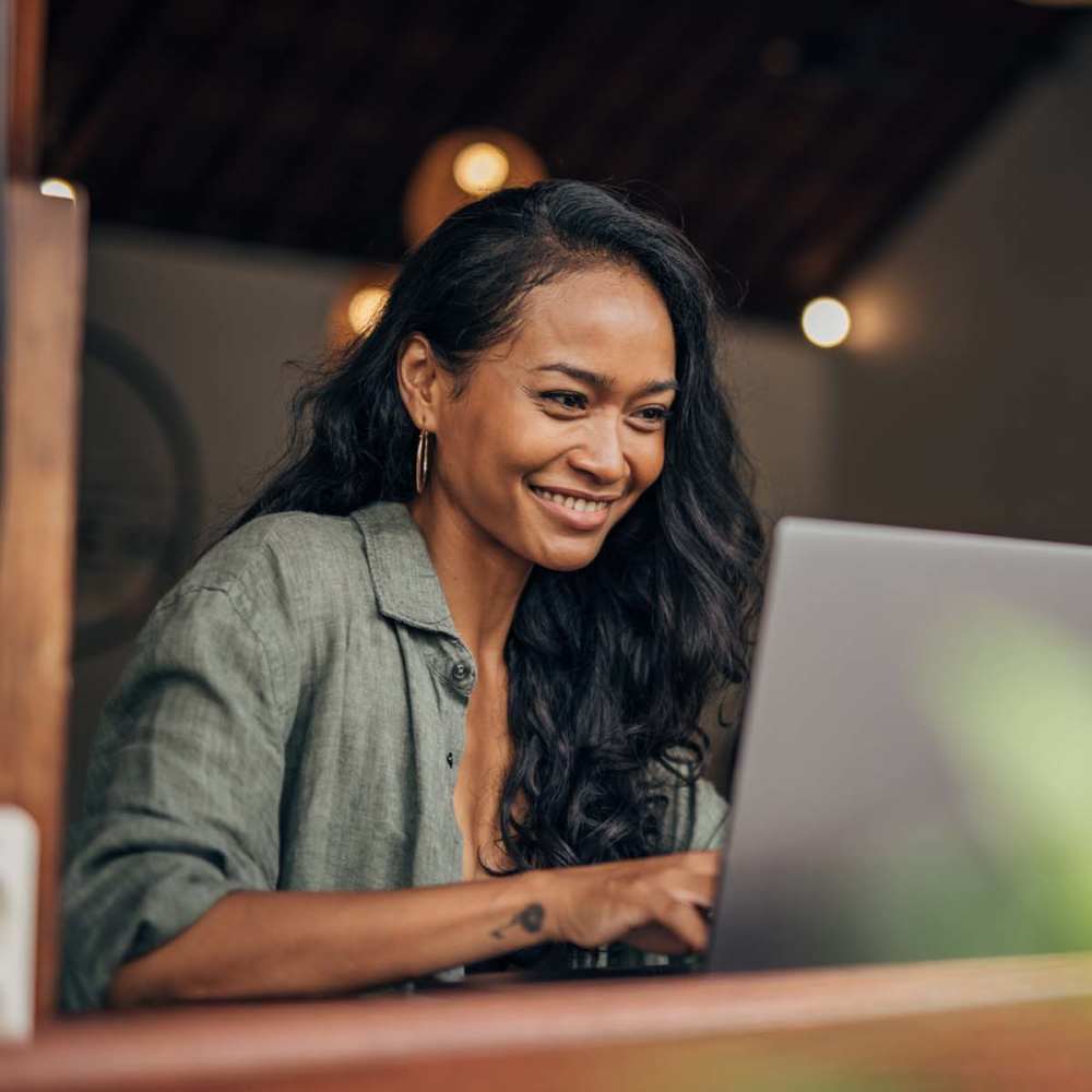 Resident working on a laptop at Amberly Trace Apartments in Burlington, North Carolina