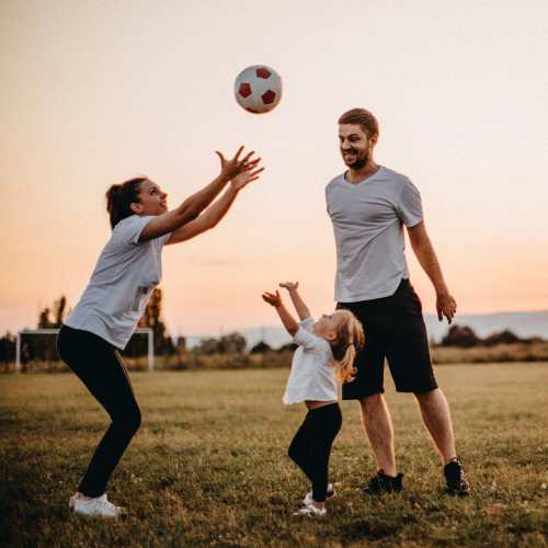 Resident family playing with a ball in a nearby park at Thickett in Mt Pleasant, South Carolina
