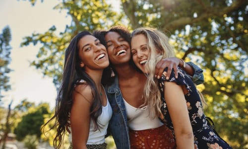 Friends hugging outside of Broadway Towers in Concord, California