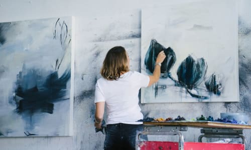 A resident paints in her apartment at Courtyard in Hayward, California