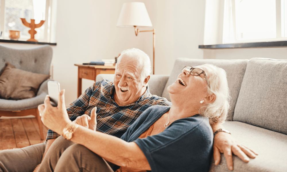 Resident couple laughing in their apartment at Mathison Retirement Community in Panama City, Florida