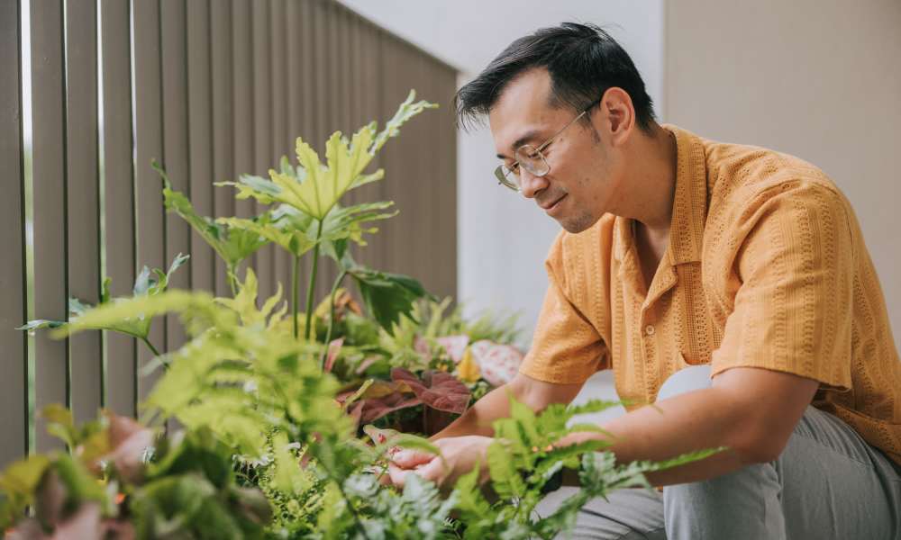 Resident watering for plants at Williston Pointe in Gainesville, Florida