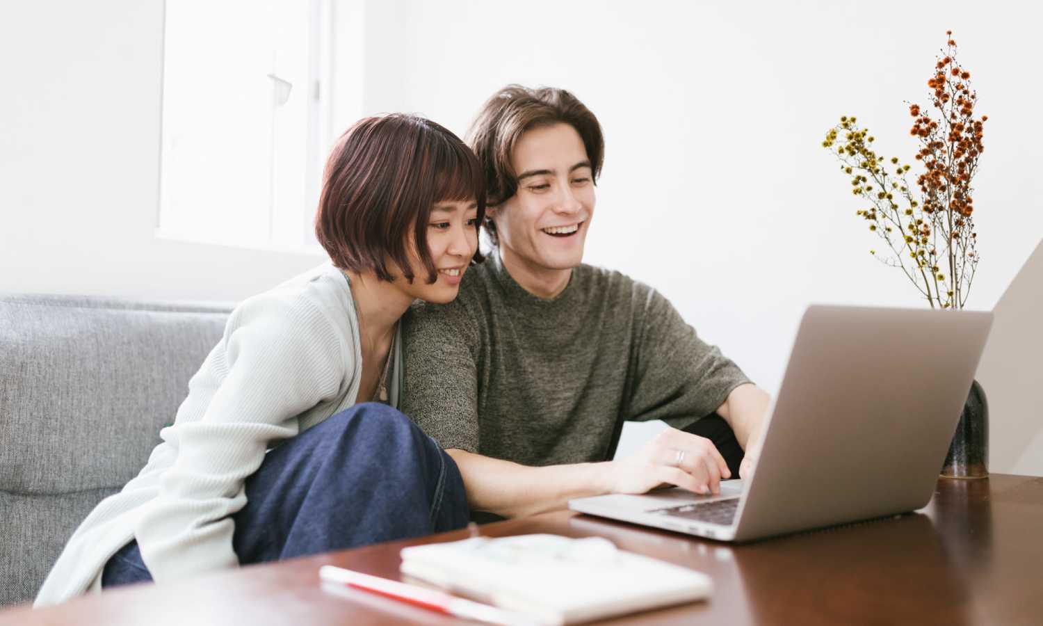 Resident couple using laptop at Georgetown Apartments in Merriam, Kansas