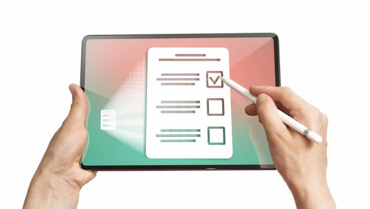 Caregiver reviewing a checklist on a tablet at {{location_name}} in {{location_city}}, {{location_state_name}}