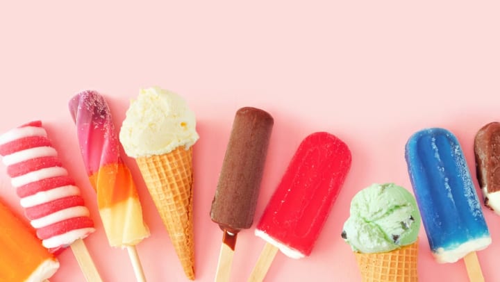 Popsicles and ice cream against a pink background