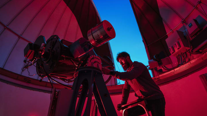 adjusting a telescope at an observatory in Flagstaff